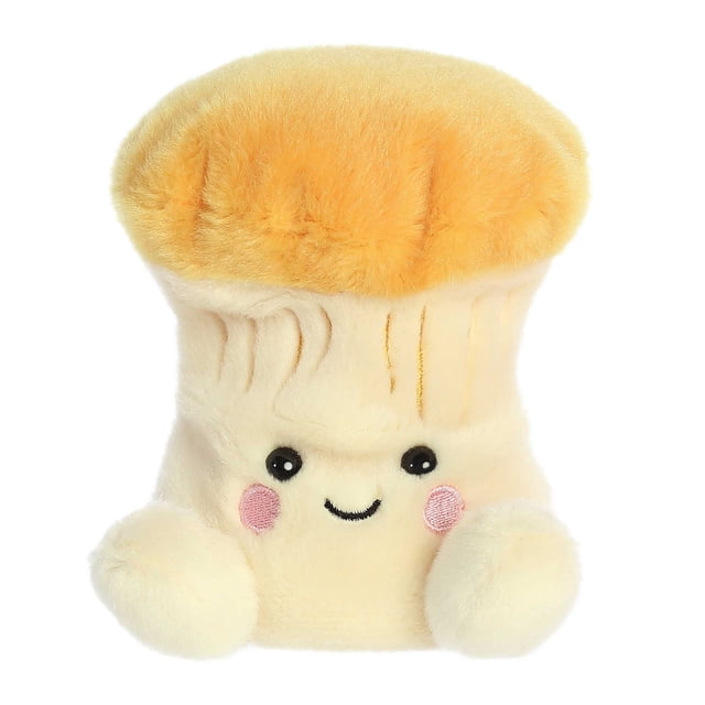 Aurora Palm Pals - Jackie Chanterelle Mushroom Peluche de 5 Pouces. Ce Champignon en Peluche Doux et Duveteux Présente un Corps de Couleur Crème avec une Calotte Jaune Doré, un Visage Souriant avec des Yeux Noirs Brodés, des Joues Roses et de Petits Bras en Peluche. Fabriqué avec des Matériaux de Haute Qualité et Rempli de Granules de Haricot pour la Stabilité, Il Convient à Tous les Âges.