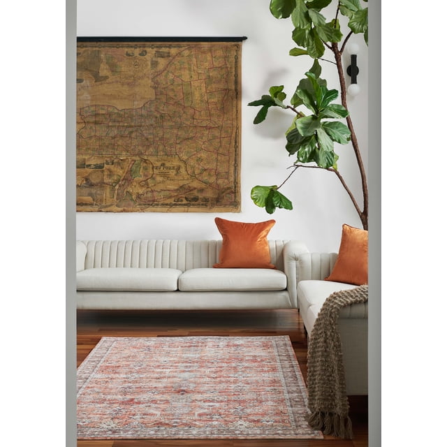 ECARPET Ruby Traditional Area Rug for Living Room, Bedroom, Dining Room, Entrance, Hallway and More, copper-colored with vintage ornate pattern and low pile, machine-made from 100% polyester, placed on hardwood floor in a living room with cream tufted sofas, burnt orange pillows, a beige textured throw, a large green fiddle leaf fig plant, and a vintage New York map on the white wall, often used to add vintage charm and durable floor coverage.