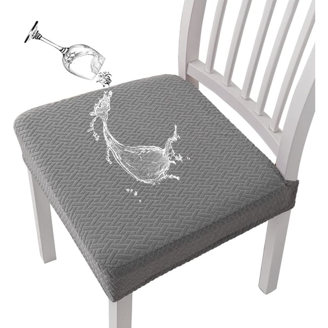 EGNMCR Stretch Chair Covers with textured grey fabric and water-resistant TPU membrane backing, shown repelling a liquid spill on a dining chair. These slipcovers are stretchy, easy to install with elastic edges, and machine washable. Ideal for dining rooms, kitchens, and events.
