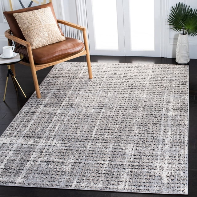 Safavieh Lagoon Lance Tapis Abstrait Présentant un Motif Abstrait à Texture Subtile dans des Tons Gris et beige Doux, Tissé Mécaniquement avec des Fils Synthétiques en pile Peluche, Posé sur un Plancher de Bois Franc Foncé à Côté d'Un Fauteuil en Bois avec des Coussins en Cuir Brun et un Oreiller beige, Convient pour Rehausser le décor du Salon Moderne.