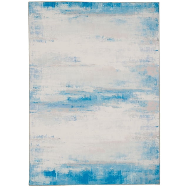 Tiana 5' x 7' washable area rug in ivory and blue featuring an abstract painterly pattern with blended soft blue and ivory tones, made of stain-resistant polyester with nonslip backing, machine washable and suitable for high-traffic family or pet-friendly spaces.