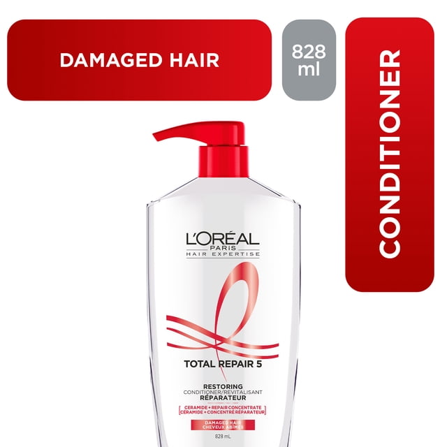 L'Oreal Paris Hair Expertise Total Repair 5 conditioner in a clear bottle with a red pump, 828 ml, formulated to repair damaged hair by restoring strength, density, vitality, shine, and silkiness with ceramide and repair concentrate.