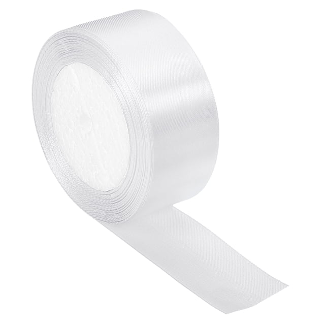 Unique Bargains 1.5 Inch Wide 24 Yards Satin Ribbon, Double Face Solid Crafts Roll for Party Home DIY Wrapping Decoration, White. A roll of white satin ribbon made of polyester, measuring 1.5 inches wide and 24.06 yards long. The ribbon has a smooth, double-faced finish and is shown partially unrolled. Ideal for crafts, gift wrapping, flower arrangements, and DIY sewing projects.