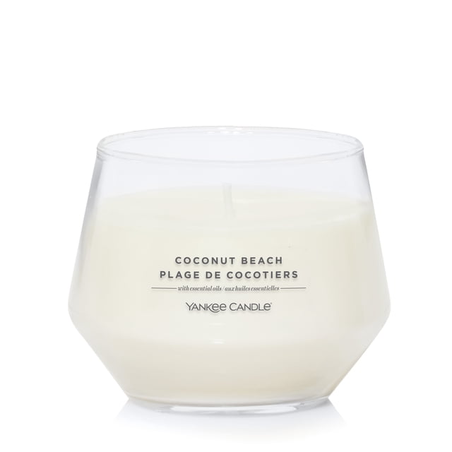 Yankee Candle Scented Candle, Coconut Beach, 10 oz, Studio Collection, white soy wax in a clear, uniquely shaped jar candle with black text label and natural fiber wick, ideal for home décor and providing up to 50 hours of burn time, often used to create a welcoming ambiance.