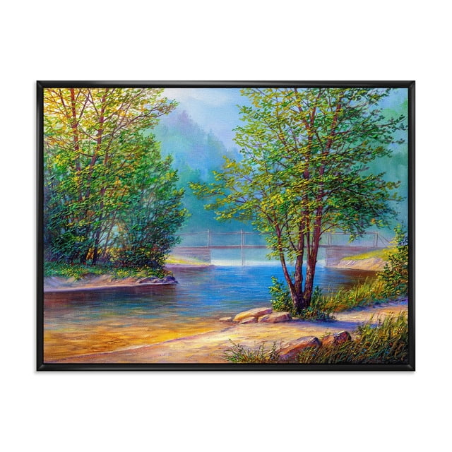 Designart Green Trees By The Riverside FLOAT FRAME WALL ART showing a framed canvas print of a riverside landscape with green trees on both banks, a calm blue river, and a faint suspension bridge in the misty background, printed on premium cotton canvas with fade-resistant ink, gallery-wrapped over a 1-inch wood sub frame, arriving ready to hang with included hardware, also suitable for enhancing home or office décor.