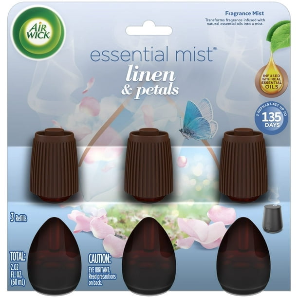 EM 0+3 LINEN&PETALS Air Wick essential mist refill pack containing three brown ribbed diffuser tops and three 2.02 fl oz (60 ml) dark amber fragrance refills with linen and petals scent infused with natural essential oils, designed for plug-in air fresheners, each refill lasting up to 135 days.