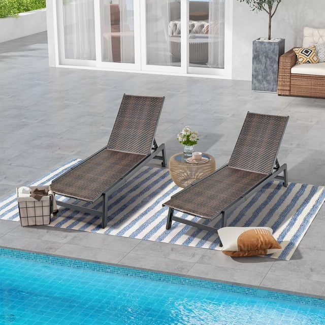 Costway 2PCS Patio Galvanized Steel Chaise Lounge with Wheels PE Rattan Recliner Chair. This set includes two outdoor chaise lounges made of mix brown PE wicker and black galvanized steel, offering durability and rust resistance. Each lounge has a 5-level adjustable backrest, including a flat position, and two smooth wheels for easy movement. The lounges are designed for poolside, garden, or backyard use, with a weight capacity of 400 lbs. The image shows the lounges on a striped rug near a pool, accompanied by a small table and outdoor decor.