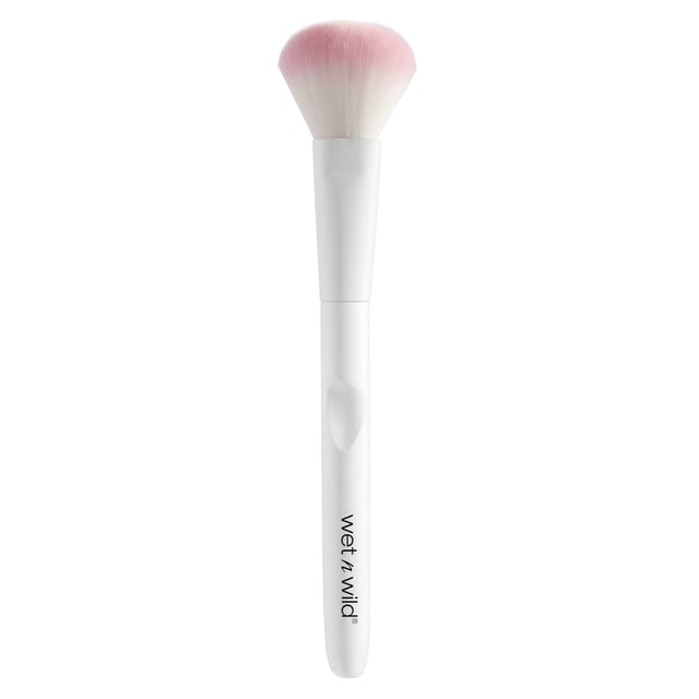 Powder Brush with a white wet n wild branded handle and large, soft, curved bristles fading from white to pink, designed for picking up and evenly applying face powder for a flawless finish.