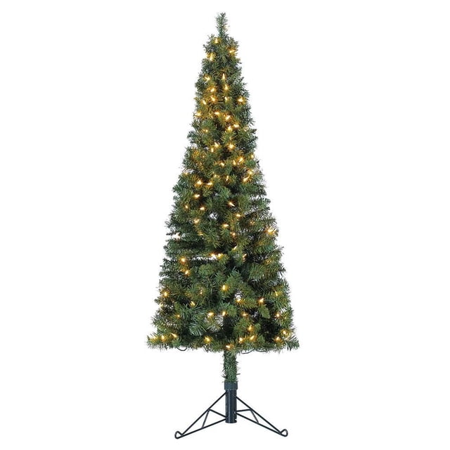 Home Heritage Corner 5 Foot 100 LED Pre-Lit Artificial Christmas Tree in green, featuring a slim profile with 224 lush PVC foliage tips and 100 warm white LED lights. The tree stands 60 inches tall and 14 inches wide, making it ideal for compact spaces or corner placement. It includes a sturdy metal stand for stability and easy assembly. Perfect for creating a festive holiday atmosphere without the hassle of shedding needles.