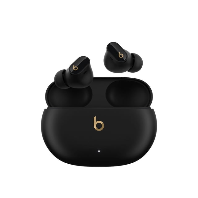 Beats Studio Buds + True Wireless Noise Cancelling Earbuds in matte black with gold 'b' logo, shown with open pocket-sized charging case and two in-ear buds with silicone ear tips, featuring active noise cancelling, transparency mode, and up to 36 hours battery life, ideal for immersive sound and clear calls.