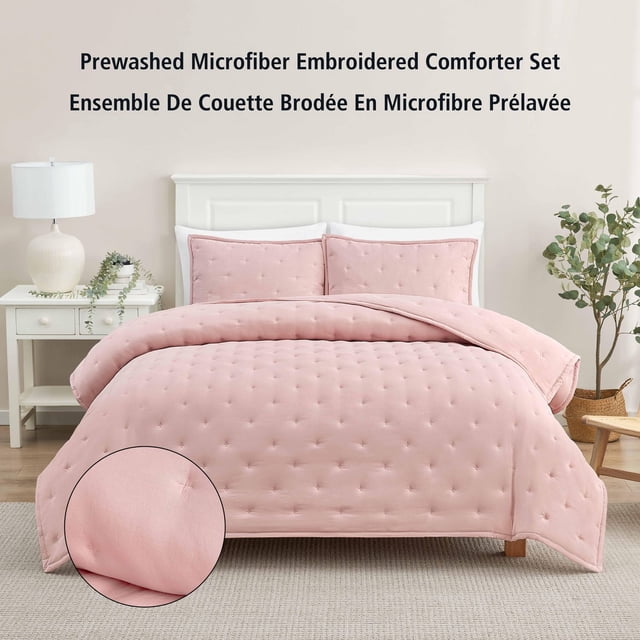 Mainstays 3-Piece Comforter Set, Pink Blush, Double Queen, featuring a microfiber comforter with embroidered tufted details and two matching pillow shams on a white bed frame in a neutral bedroom setting with a nightstand and plants, ideal for adding comfort and style to bedroom décor.