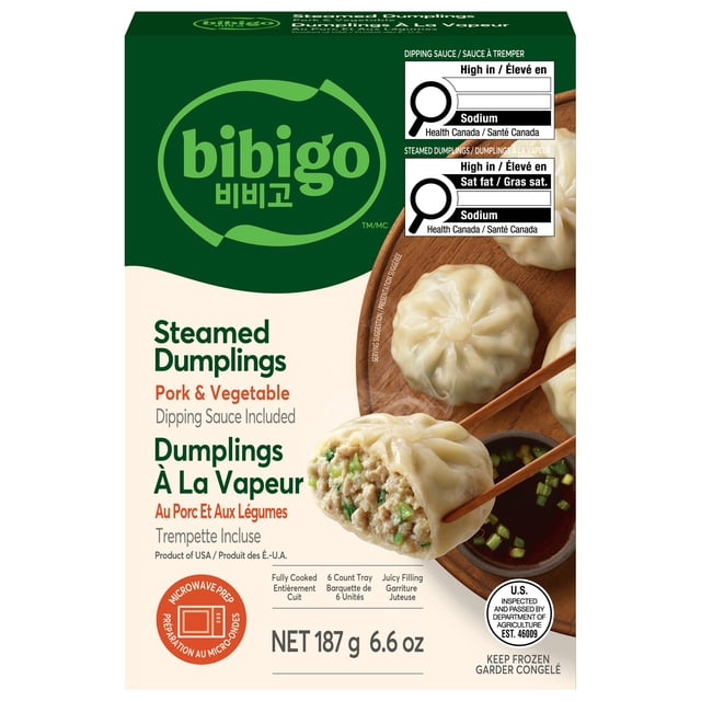 bibigo Steamed Dumplings Pork & Vegetable, 187 GR front-facing view of six thin-wrapped frozen dumplings filled with pork, cabbage, green onion and tofu, with included soy/vinegar sauce packet; ideal Korean-style appetizer and often used added to soups.