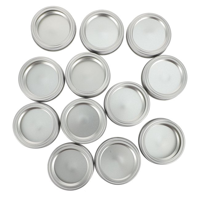 12 Sets Regular Canning Jar Bands and Rings Set 70mm Replacement Canning Lids made of durable tinplate material. These silver-coloured lids are designed for preserving food, offering a secure seal to keep items like sauces, fruits, spices, and sweets fresh. The set is easy to clean, resistant to high and low temperatures, and prevents food residue corrosion. Ideal for pairing with mason jars for storage of cookies, tea, coffee, or other small items.