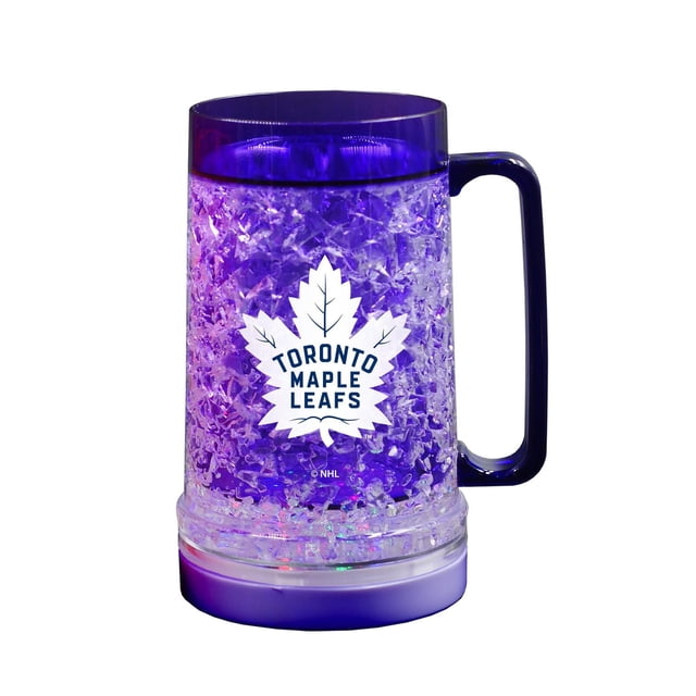 The Sports Vault Tasse de Congélation Lumineuse Maple Leafs de Toronto avec Plastique à Double Paroi et Isolation en Gel Cristal Congelable, avec un logo Maple Leafs de Toronto Blanc, Poignée et Rebord Bleu Foncé, et une base DEL Amovible Qui s'Illumine en Bleu et Violet, Capacité de 16 oz, Idéale pour Garder les Boissons Froides Tout en Montrant la Fierté de l'Équipe.