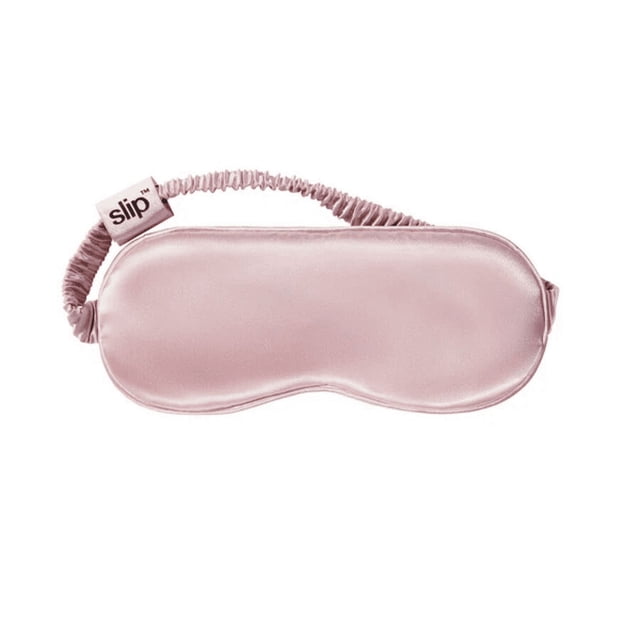 Slip - Pink Pure Silk Sleep Mask featuring a smooth, luxurious mulberry silk surface in a soft pink hue. The mask includes a gentle, adjustable elastic band for a secure and comfortable fit. Designed to reduce sleep lines, minimize hair breakage, and enhance skin hydration, it is suitable for all skin types and nighttime routines.