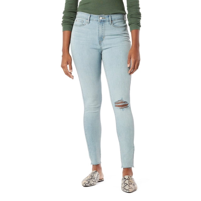 Levi Strauss Signature.™ Women's High Rise Skinny Jeans in light blue denim with a distressed rip on the right knee, featuring a high waist, skinny leg opening, zip fly, and 5-pocket styling with a 29-inch inseam, shown on a model wearing a green ribbed long-sleeve top and snakeskin slip-on shoes, ideal for casual or date night wear.