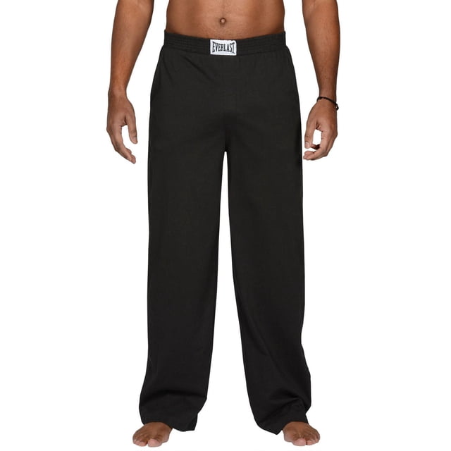 Everlast Jersey Pajama Pant in black shown front-facing on a male model from waist to feet, featuring a loose fit with elastic waistband and white Everlast logo patch, made from breathable 100% cotton fabric with two side pockets, suitable for lounging, sleeping, or light activities.