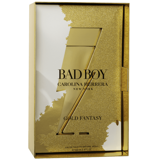 Carolina Herrera Bad Boy Gold Fantasy 100ML eau de Toilette for Men, featuring a gold-toned lightning bolt-shaped bottle in a glittery gold box. This amber woody fragrance, launched in 2022, includes notes of lava, white pepper, tonka bean, and rose.