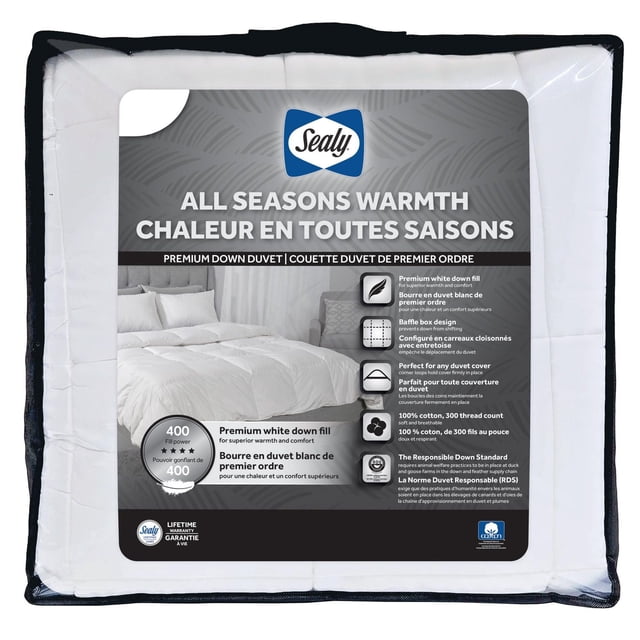 Sealy All Season Down Duvet in white packaging with label showing a bed with white bedding, highlighting premium white down fill for all seasons warmth, baffle box design to prevent shifting, 100% cotton 300 thread count breathable fabric, corner loops to secure duvet cover, machine washable, and Responsible Down Standard certification.