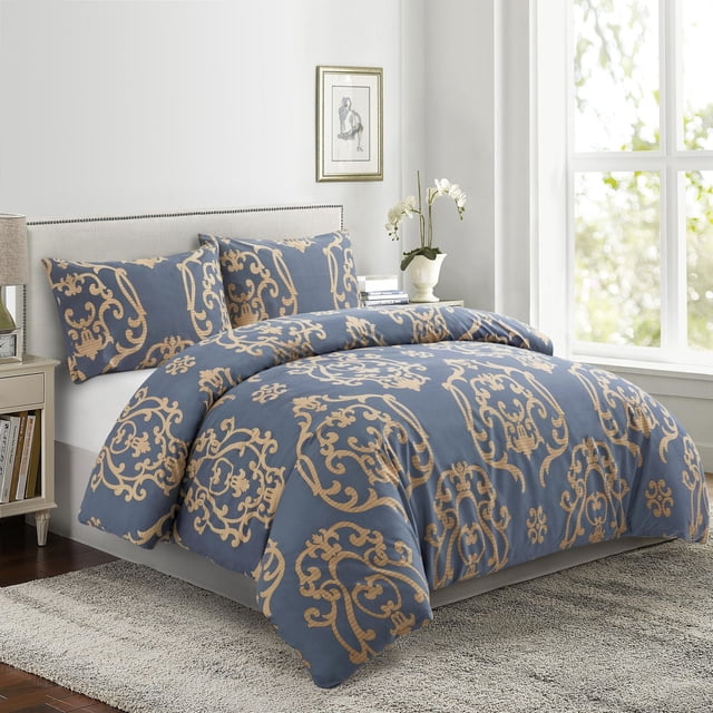 Marina Decoration Ultra Soft Silky Zipper Rich Printed Rayon from Bamboo All Season Duvet Cover Set with Pillowcases in navy blue with gold floral damask patterns, displayed on a bed with a beige upholstered headboard in a bright room with a window and nightstand, featuring a hidden zipper for easy duvet insertion and breathable, wrinkle-resistant fabric suitable for all seasons.