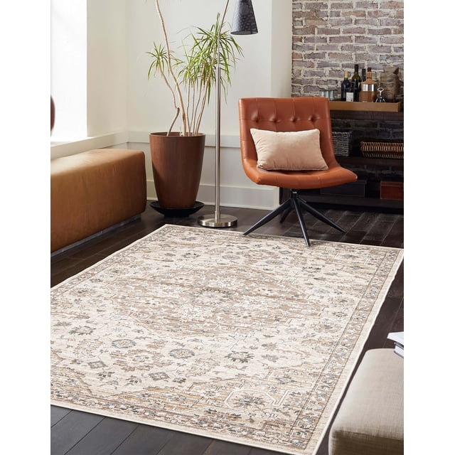 ECARPET Arden Traditional Area Rug with beige and muted floral medallion patterns on dark hardwood floor, shown in a living room with a brown leather swivel chair with beige cushion, tall potted plant, stainless steel floor lamp, and brick accent wall with shelf holding bottles and decor, ideal for living rooms, bedrooms, or hallways.