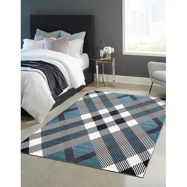 ECARPET washable plaid area rug and runner in aqua with a low, non-shed pile featuring a digitally printed intricate plaid pattern in white, black, and blue, placed on a light floor beside a bed with white and blue bedding in a modern bedroom with gray walls and a glass side table, suitable for high traffic areas.