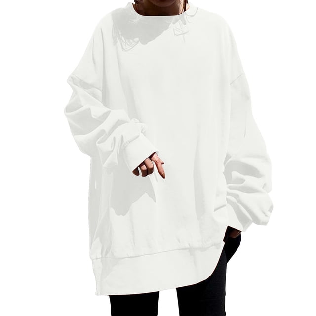 Timegard Sweatshirts for Women Plus Size Crewneck Pullover Drop Shoulder Long Sleeve Oversized Tops in a solid white color. The sweatshirt features a relaxed fit with drop shoulders, a crewneck design, and long sleeves. It is styled with a slightly curved hemline and paired with black pants, showcasing its oversized silhouette. Suitable for layering with cardigans or jackets, and ideal for casual wear in spring, summer, or fall.