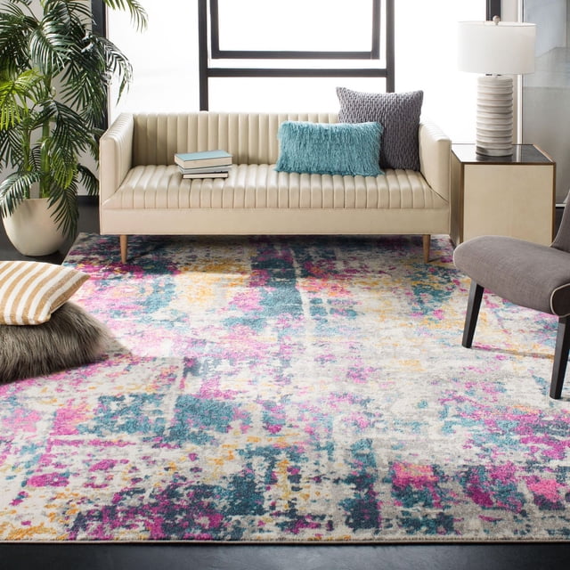 SAFAVIEH Madison Tapis Ivoire Abstrait Présentant un Motif Abstrait Multicolore dans des Tons Ivoire, Rose, Sarcelle et Jaune, Placé dans un Salon Moderne avec un sofa en Cuir beige avec Capitonnage à Canaux Verticaux, des Coussins Sarcelle et Gris, une table d'Appoint avec une Lampe Blanche, une Chaise Grise et une Plante en Pot. Ce Tapis en Polypropylène durable Convient à la Déco Intérieure Contemporaine et Transitionnelle et Est Souvent Utilisé pour Ajouter un accent Stylé aux Zones d'Assise.