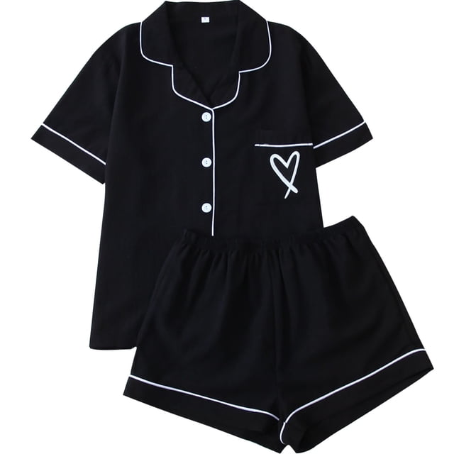cfhntfmh Womens Pajama Sets Pj Set featuring a cute heart print design. This 2-piece set includes a short sleeve button-down shirt with white piping and matching shorts, both in black fabric. Made of soft, breathable, and lightweight material, it is ideal for sleepwear, loungewear, or casual wear. The shirt has a front pocket with a heart print, and the shorts have an elastic waistband for comfort.