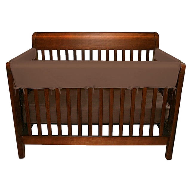 Jolly Jumper Soft Rail 3-Piece Set for Convertible Cribs in brown, including one front rail cover and two side covers installed on a wooden crib to protect baby’s gums during teething and prevent crib rail damage.