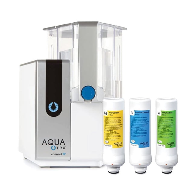 AquaTru Connect Countertop Water Filter Purification System with exclusive 4-stage ultra reverse osmosis technology, shown with its sleek, compact design in white and silver. The system includes a 1-gallon capacity tank and three replacement filters labeled for pre-carbon, reverse osmosis, and VOC carbon filtration. BPA-free and designed for easy use without plumbing or installation, it effectively reduces up to 99% of over 1,000 contaminants, including lead, fluoride, and chlorine.