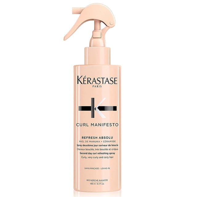 Kerastase Curl Manifesto Refresh Absolu Redefining & Restyling Spray 6.4 oz bottle with a peach-toned design and ergonomic spray nozzle. Ideal for redefining curls, reducing frizz, and enhancing shine. A lightweight hair spray for daily use or refreshing second-day curls.