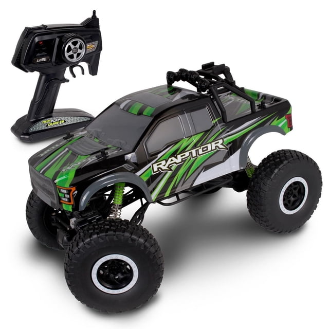 NKOK 4x4 Xtreme Ford F-150 Raptor Jouet RC à l'Échelle 1/10 Montré dans une Vue avant 3/4 avec une Carrosserie Noire et Verte avec des Graphiques « Raptor », des Pneus Surdimensionnés à Bouton-Pression avec des Jantes Blanches à Perle, une suspension à Ressorts Verte et une cage de Retournement Noire avec Quatre Lumières Montées. Comprend une Télécommande à Poignée de Pistolet 2,4 GHz avec Volant et Commandes de Gâchette.