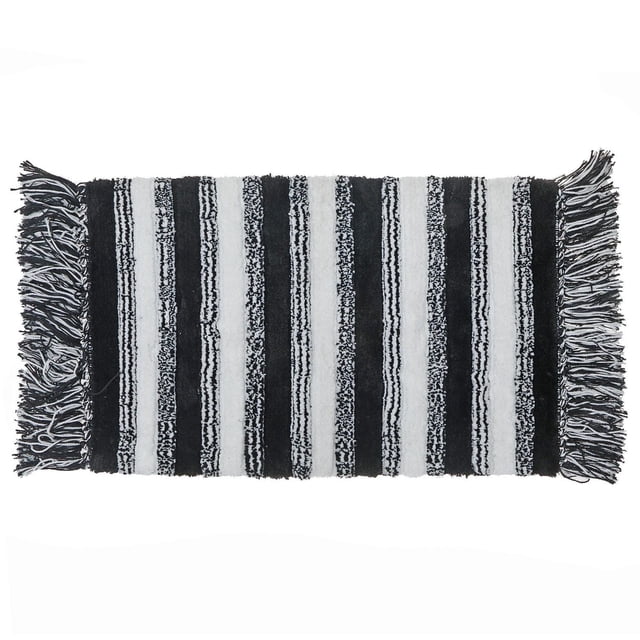 Microfibre Striped Bath Mat With Fringe Black 20X32 inches, rectangular polyester mat with black and white vertical stripes and fringe on both ends, highly absorbent and machine washable, suitable for bathroom or kitchen use.