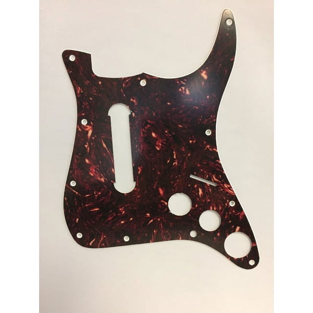 Rock Band 4 Tortoise Shell Guitar Pick Guard Replacement by Mad Catz, a guitar accessory designed for Fender Stratocaster guitars. Features a marbled tortoise shell pattern with pre-drilled holes for easy installation. Officially licensed accessory for protecting or replacing the pick guard.