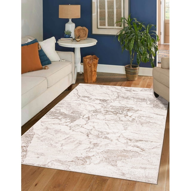 ECARPET Nala Contemporary/Modern Area Rug with abstract beige and light brown patterns and soft texture, placed on hardwood flooring in a living room with beige sofas, blue and rust cushions, a white round side table with a lamp and decor, and a potted green plant against a navy blue wall, ideal for living rooms, bedrooms, or hallways.
