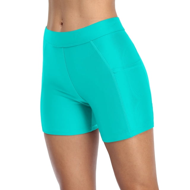 Shorts de Planche Longs pour Femmes avec Poches, Bas de Maillot Unis, Trunks de Couleur Sarcelle Vibrante. Fabriqués à Partir de 82 % de nylon et 18 % d'Élasthanne, Ces Shorts de Bain Extensibles, Légers et Durables Offrent une Coupe Taille Haute pour un Ajustement Flatteur et un Léger Contrôle du Ventre. Le style Shorty Offre Plus de Couverture et de protection, Tandis Que les Véritables Poches Latérales Offrent une Commodité pour Tenir de Petits Articles comme des Clés Ou des Attaches pour Cheveux. Convenant à la Natation, à la Randonnée, au Vélo, au yoga et à d'Autres Activités