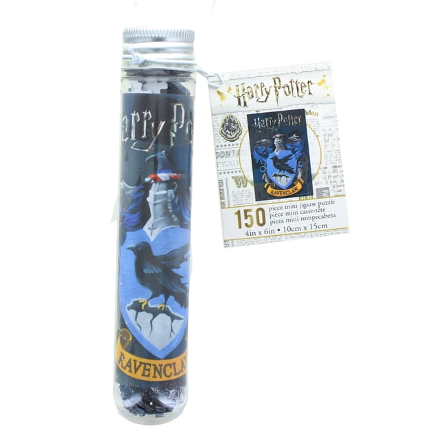 Harry Potter House Ravenclaw 150 Piece Micro Jigsaw Puzzle in a clear test tube with a silver cap. The tube features the Ravenclaw crest with a blue raven and shield design, along with the word 'Ravenclaw' on a gold banner. A tag attached to the tube displays the Harry Potter logo, puzzle dimensions of 4 x 6 inches (10 x 15 cm), and the piece count. Suitable for fans of Harry Potter and puzzle enthusiasts.