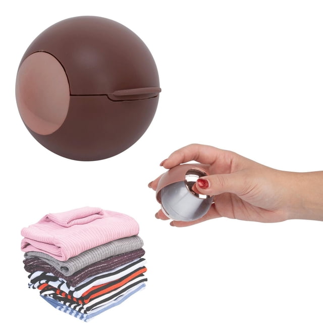 Perfect Solutions Easy Lint Remover, a compact round brown tool with rose gold accent, shown closed and held in hand, designed for efficient lint and pet hair removal from clothes and laundry, displayed next to a stack of folded garments including pink, gray, and striped fabrics, suitable for on-the-go use and fabric care.