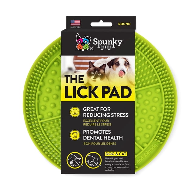 Lick Pad Dog Toy by Spunky Pup, a round green non-toxic TPR rubber treat-spreader with textured raised nubs and ridges, designed to reduce stress and promote dental health for dogs and cats during grooming or thunderstorms.