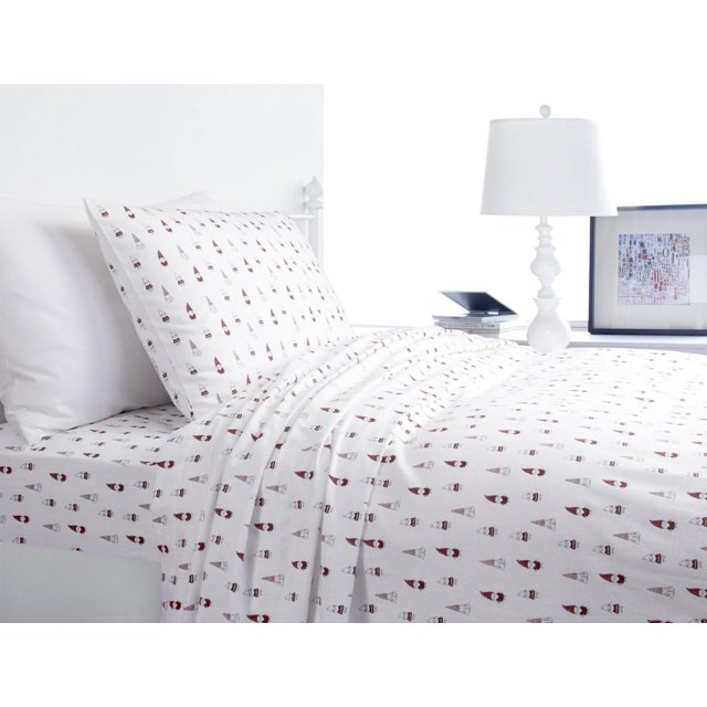 Royale Flannel Sheet Sets with white 100% cotton flannel fabric featuring a repeating pattern of small red and grey gnome figures, displayed on a made bed with matching pillowcases in a bright, minimalist bedroom with a white lamp and framed artwork, ideal for adding warmth and comfort to a child's room.