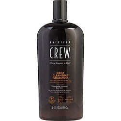 AMERICAN CREW by American Crew DAILY CLEANSING SHAMPOO in a 33.8 oz bottle. The shampoo offers a refreshing, oriental, and woody fragrance, suitable for daily use and various occasions. The black bottle features a minimalist design with orange and white text, highlighting the brand and product details.