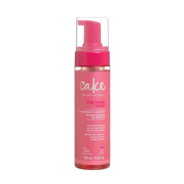 Cake Beauty The Thick Trick Volumizing Styling Foam in a 200 ml pink bottle with clear pump dispenser, designed for strand thickening and go-so-big styling with feather-light fullness, cruelty-free and vegan, suitable for adding volume without stickiness.