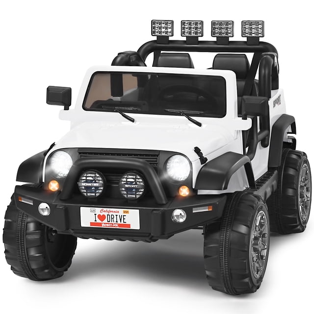 Patiojoy 12V Electric Kids Ride On Truck Toys 2 Seater Jeep Car with Remote Control in white. This ride-on toy features a realistic design with bright LED lights, a front grille, and rugged black tires. It includes two wide seats with safety belts, a remote control for parental guidance, and a back storage box. The car is equipped with a 12V rechargeable battery, forward/reverse switch, high/low speed options, and a foot pedal for a realistic driving experience. Additional features include a USB interface, TF slot, AUX port, and spring suspension for smooth rides on various terrains.
