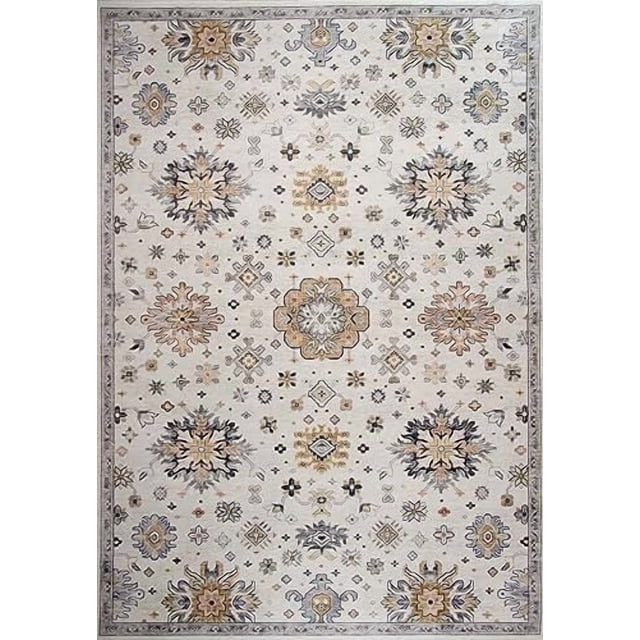 Vintage distressed cream and gold indoor area rug featuring intricate floral and geometric motifs in a symmetrical layout.