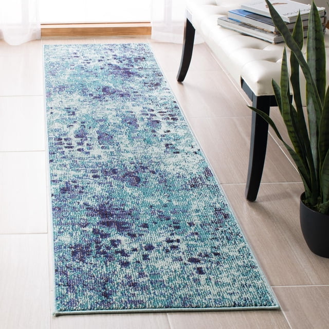 SAFAVIEH Madison Candelario Abstract Polka Dots Area Rug with a durable power-loomed design in blue and teal abstract polka dot pattern, placed on a light wood floor next to a white bench and snake plant, ideal for transitional runner rug use and suitable for hallways or entryways.
