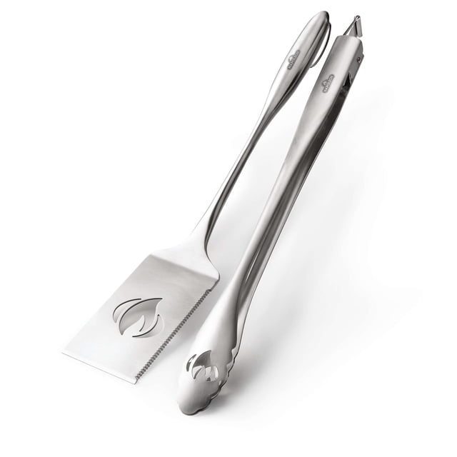 PRO Stainless Steel 2 Piece Toolset with a spatula featuring a serrated edge and flame cutout, and tongs with scalloped tips and flame design, both made of brushed stainless steel, ideal for BBQ grilling and outdoor cooking, also suitable for serving food.