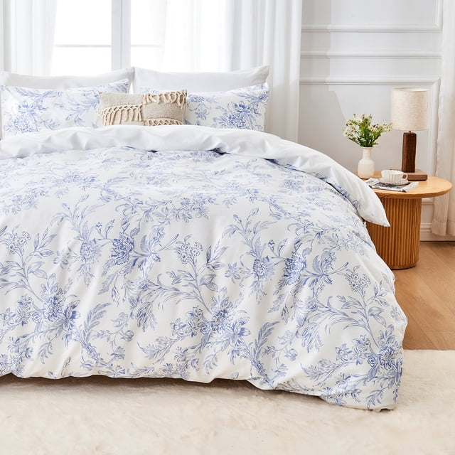 Hitime Queen Duvet Cover Set, a 3-piece bedding set made of soft and breathable microfiber with a blue floral watercolor pattern. Includes one queen-size duvet cover and two pillowcases. Shown in a well-lit bedroom with a wooden side table and decorative accents, highlighting its elegant design.