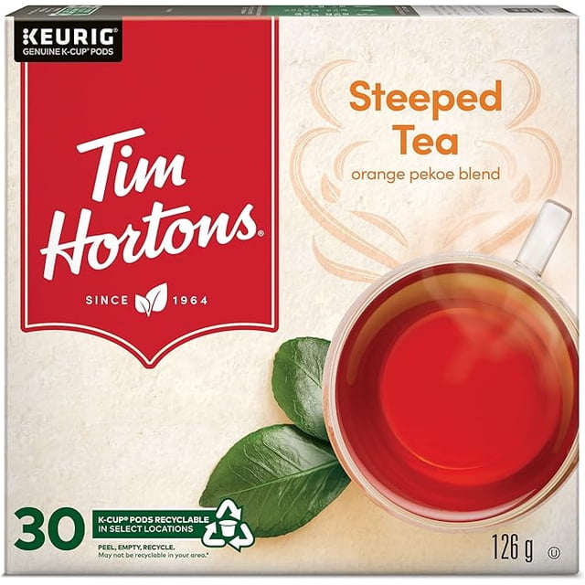 Tim Hortons Steeped Orange Pekoe Tea, Single Serve Keurig K-Cup Pods, 30 count box with bold branding. Includes two packs for a total of 60 pods. Features recyclable K-Cup pods and a rich orange pekoe tea blend. A steaming cup of tea and fresh tea leaves are prominently displayed.