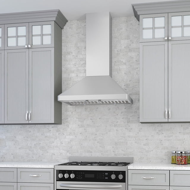 Ancona 36" Galleria Pyramid Wall Mount Range Hood in Stainless Steel installed in a modern kitchen. The wall-mounted pyramid-style range hood features high-grade 430 stainless steel construction, a 4-speed rotary control system, and a powerful 600 CFM ventilation system. It includes slanted, dishwasher-safe baffle filters and a sleek, minimalist design that complements the surrounding grey cabinetry and tiled backsplash.